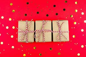 Christmas gifts box on red background. New Year 2021, holidays and celebration concept. Flat lay photo