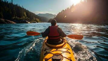 Rear view of man riding kayak in stream with background of beautiful landscape. photo