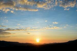 Silhouette sunrise at mountains photo