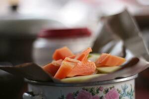 Close up view of person slicing various fruits to make salad or rujak.Indonesian specialty food. photo