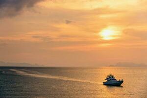 Speedboat returning during the sunset photo