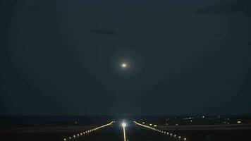 A night view of a runway with a taking off plane video