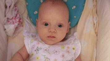 Portrait of baby girl in pram looking to the camera video