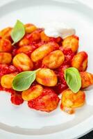 gnocchi potato dish tomato sauce no meat appetizer meal food snack on the table copy space food background rustic top view photo