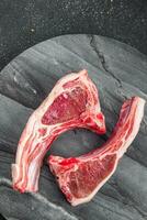 raw lamb meat cutlet on the bone slice food snack on the table copy space food background rustic top view photo