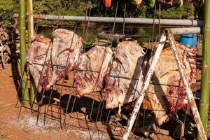 hanging beef meat roasting outdoors photo