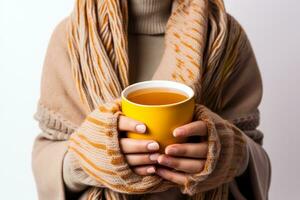 Person sipping hot tea for autumn flu isolated on a white background photo