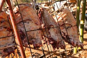 hanging beef meat roasting outdoors photo