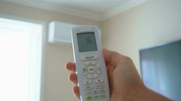 Using remote controller to turn on air conditioner. 4k stock footage. video