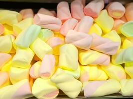 colorful marshmallows in a glass jar photo