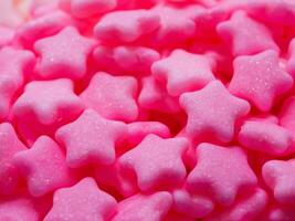 pink stars candies background, close up photo