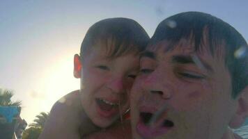 Father teaching son to dive in the pool video