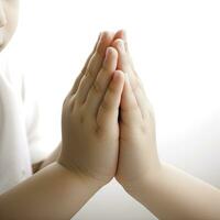 Childs Hands in Prayer Position on White Background photo