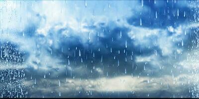 Raindrops on Glass with Beautiful Blue and White Sky Background photo