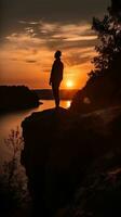 Solitude at Sunset Person Silhouette Admiring the View from Cliff Edge photo