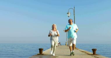 Senior couple having morning jog with music video