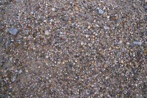 Background texture of small pebbles on the surface of the road photo