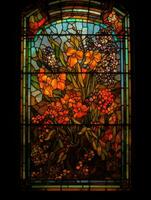 Stained glass window with the image of orange flowers photo