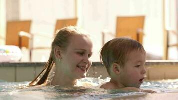 Mother and her son in the swimming pool video