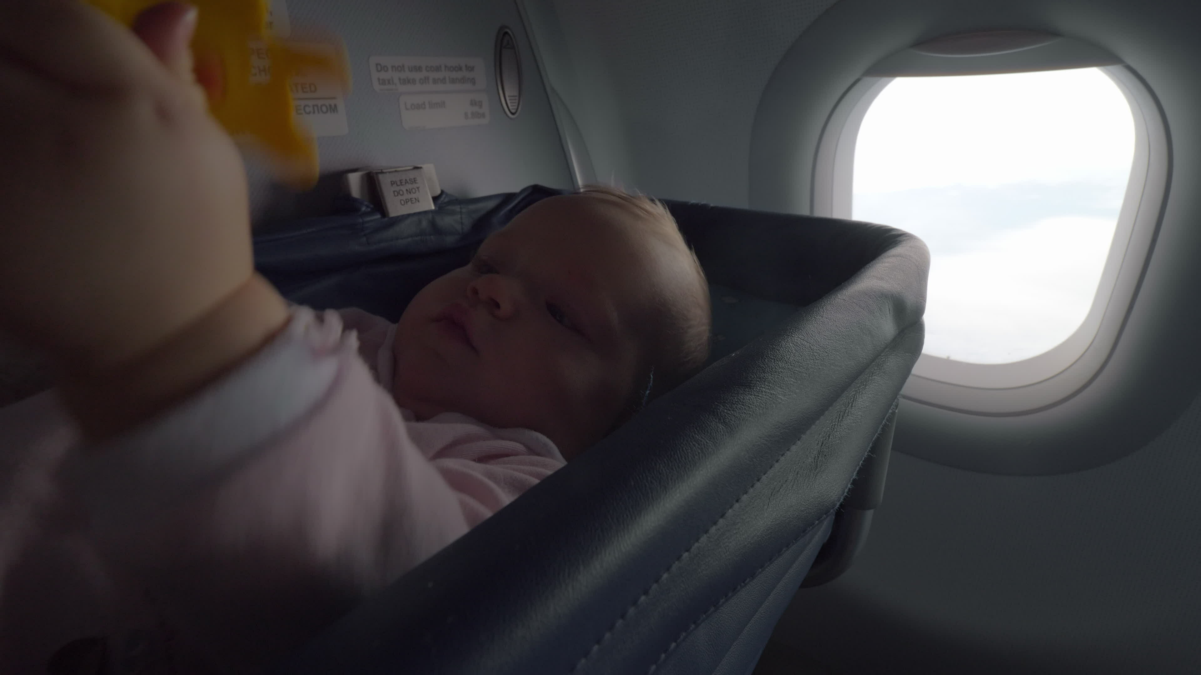 https://static.vecteezy.com/system/resources/thumbnails/030/049/219/original/playful-baby-with-toy-in-special-plane-bassinet-video.jpg