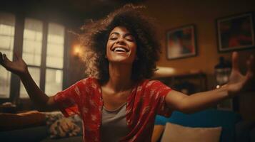 A Joyful African American Woman Dancing on her Sofa photo