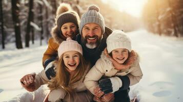 Parents and children sledding down snowy hill together photo