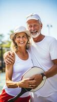 Mature couple enjoying a game of pickleball outdoors photo