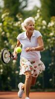 Elderly woman playing tennis with a smile on her face photo