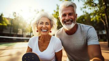 Mature couple enjoying a game of pickleball outdoors photo