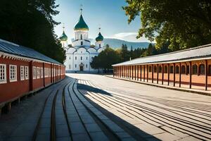 a train tracks and a red building with white domes. AI-Generated photo