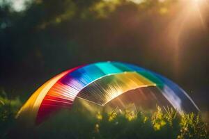 un arco iris de colores cometa en el césped. generado por ai foto