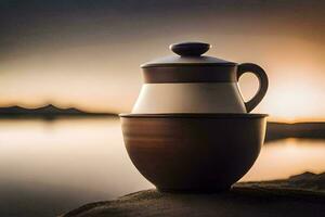 a teapot and cup sitting on a rock near the water. AI-Generated photo
