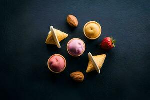 a variety of ice cream cones with strawberries and almonds. AI-Generated photo