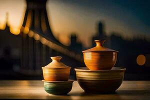 three bowls and a vase on a table in front of a city skyline. AI-Generated photo