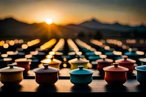colorful tea pots are lined up in front of a mountain. AI-Generated photo