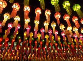 Colorful look up and bottom view of Thai Lanna style lanterns to hang in front of the temple on night time in Loy Kratong Festival. photo