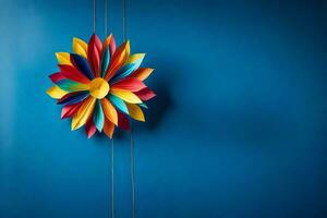 colorful paper flower hanging on a blue wall. AI-Generated photo