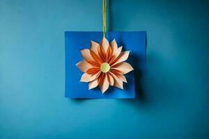 papel flor colgando en azul antecedentes. generado por ai foto
