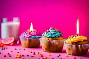 three cupcakes with candles and milk on a pink background. AI-Generated photo