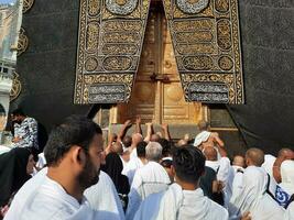 Mecca, Saudi Arabia, Aug 2023 -  Pilgrims from all over the world gather near the door of the Kaaba in Masjid Al Haram. photo