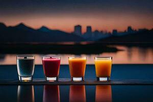 four glasses of juice are lined up on a table with a city in the background. AI-Generated photo