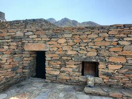 Al Bahah, Saudi Arabia, Sep 2023 - Beautiful daytime view of the historical ruins of Thee Ain Zee Ain or Dhee Ain  Ancient Village in Al Bahah, Saudi Arabia. photo