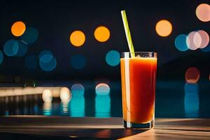 un vaso de naranja jugo con un Paja sentado en un mesa en frente de el agua. generado por ai foto