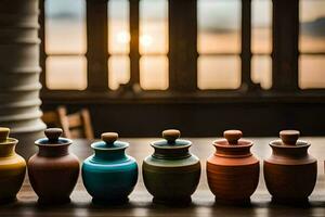 a row of colorful ceramic jars lined up on a table. AI-Generated photo