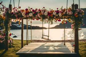 a swing with flowers on it by the ocean. AI-Generated photo