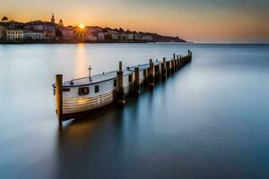 a boat sits on the shore at sunset. AI-Generated photo