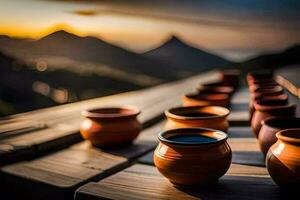 té tazas en un de madera mesa con montañas en el antecedentes. generado por ai foto