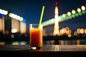 a glass of orange juice with a green straw sitting on a table in front of a city skyline. AI-Generated photo