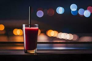 un vaso de rojo jugo sentado en un mesa en frente de un ciudad a noche. generado por ai foto