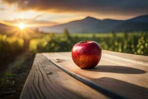 un manzana se sienta en un de madera mesa en frente de un puesta de sol. generado por ai foto